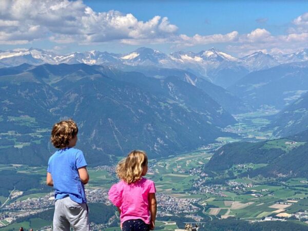 Children overlooking mountains during hike