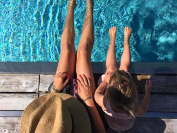 Feet dangling in the swimming pool