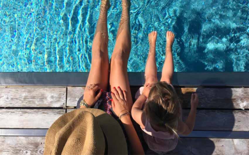 Feet dangling in the swimming pool