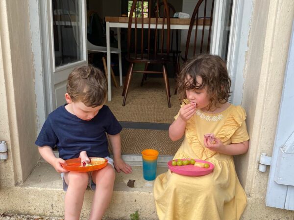 Kids eating outside cottage at the French gites