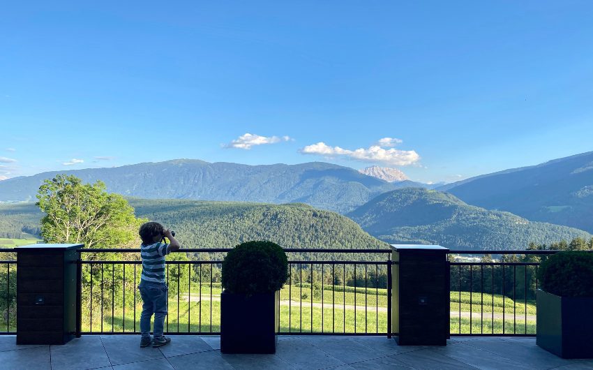 Boy using binoculars at the South Tyrolean Panorama Retreat