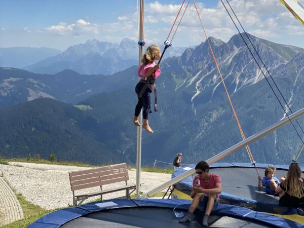 Girl on giant trampoline bungeejumping