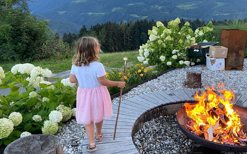 Girl with marshmallow on a stick at the South Tyrolean Panorama Retreat