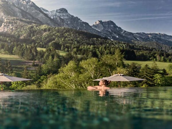 Outdoor pool with mountain views in summer at the Austrian Nature Escape