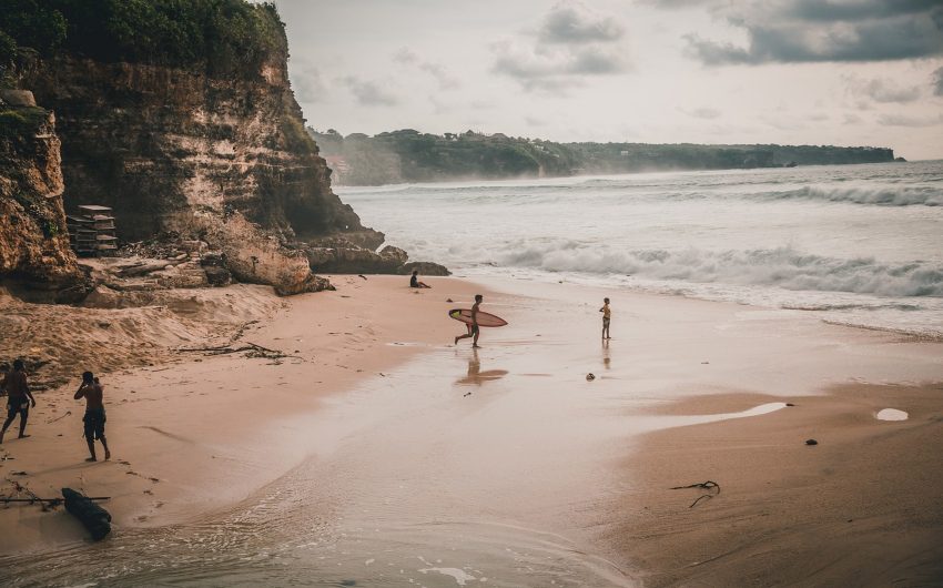 Surfers on the beach at Bali island