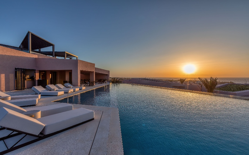 Sunset at the main pool at Domos Novos Santorini